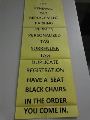 Sign for musical chairs. No number to renew tag, just keep moving down the line of black chairs. : /