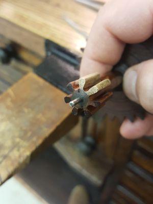 Repairing pinion leaves in an early American woodworks clock.