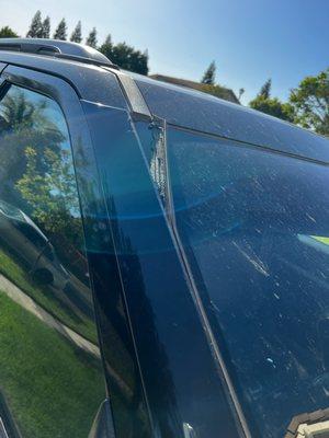 Detached windshield moulding and weatherstripping.