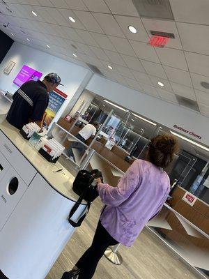 1 teller and the customer talking to guy about down payments needed on a car