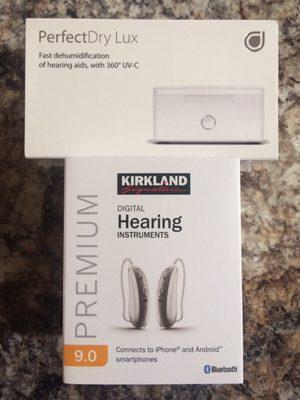 Hearing aids (bottom) and ultraviolet cleaning kit (top)