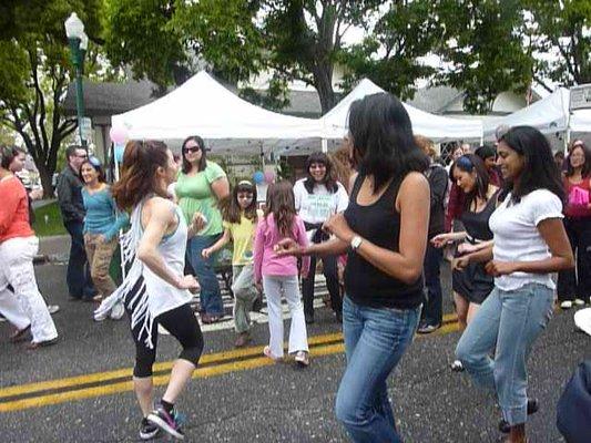 My zumba teacher leading our flash mob at the farmer's market.  She inspires us with her solid fitness instruction and cut up t-shirts.