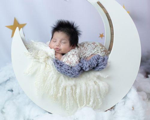 Newborn portrait studio with moon prop