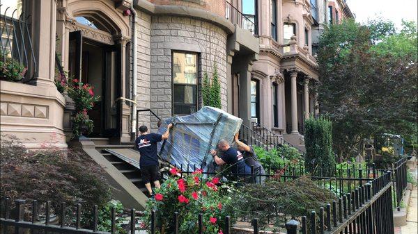 An 800 LB Baby Grand Piano being moved safely and smartly, into a Boston condo.