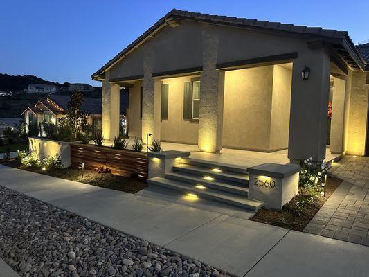 Front entry way, pillars, porcelain pavers, wood decorative wall, landscaping