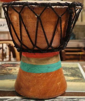 WOODEN BONGO WITH 3 BANDS OF COLOR ON BASE.