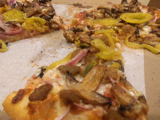 The pizza you are looking at here has, sauteed mushrooms, banana peppers, onions, cheese, sausage, and black pepper