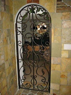 This decorative wrought iron wine cellar door in Tustin Hills, CA helped capture that old world look and feel our client wanted.