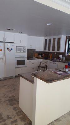 The completed kitchen cabinets after a white conversion varnish has been applied.