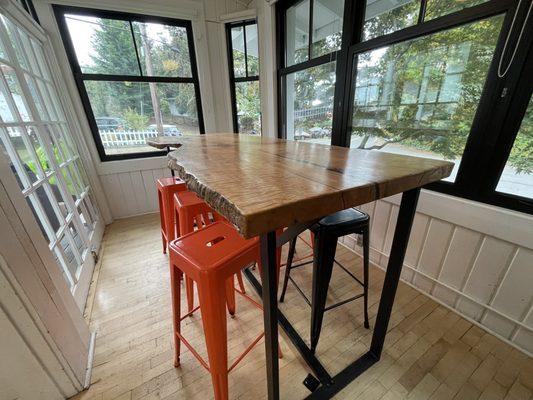 Large wood-slab table to dine, read the paper, or play games.