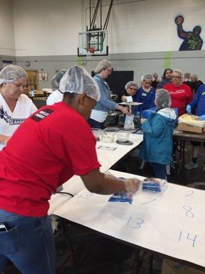 Volunteers packing the food. 47,520 food packs were filled in a four hour period today. The food is headed for Guatemala.