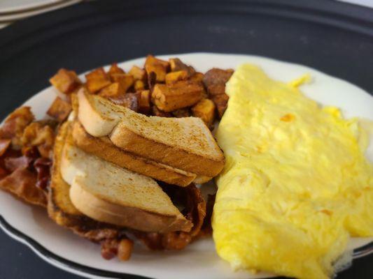 Cheese omelet with toast, home fries and bacon.