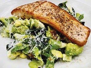 Salmon over an avocado salad