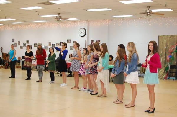 Ladies on one side, learning basic steps from the instructors.