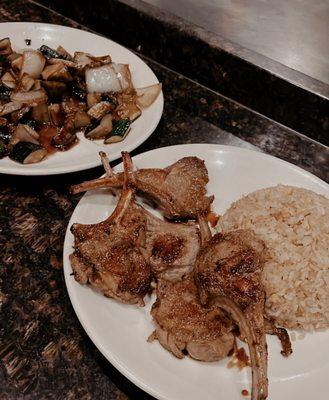 Lamb rack with fried rice and vegetables.