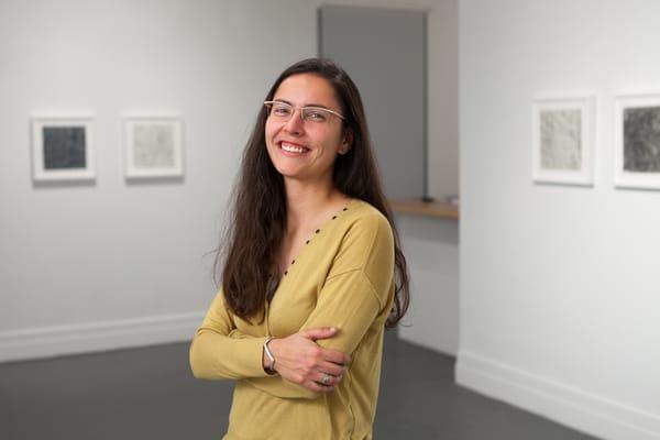 Portrait of an artist in her exhibition.