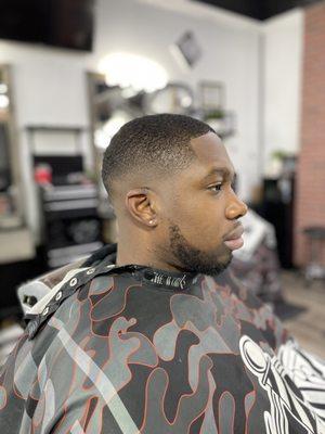 Low skin fade, low Ceaser cut.