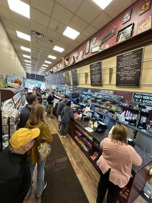 People in line ordering food at the establishment.