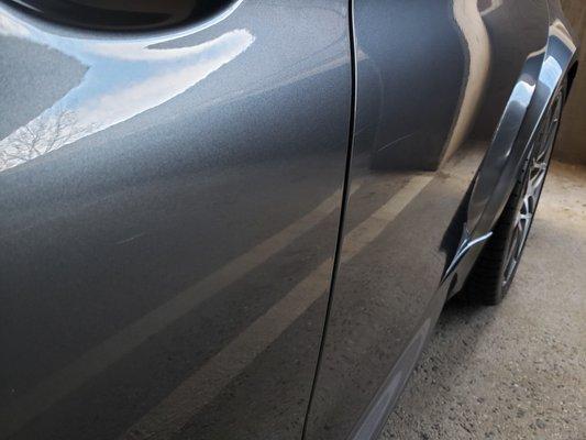 Driver side driver passenger door scratches. This photo doesn't show the car wash guys trying to cover it up.