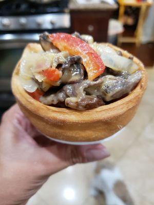 Tapa Fili Cheesesteak in a French bread cone.