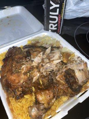 Jerk chicken with cabbage and yellow veggie rice with curry sauce on top