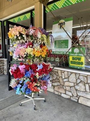 Outside: flowers displayed outside; new $1.25 pricing info posted in window