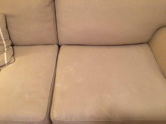 MULTIPLE white spots on couch cushion cover after being dry cleaned here.