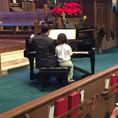 A teacher playing a duet with his student at the 2015 Winter Recital.