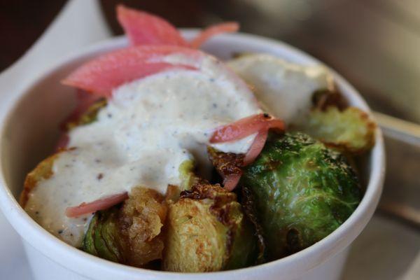 Crispy Brussel Sprouts with pickled onion, grana padano, garlic crunch, black pepper parmesan dressing