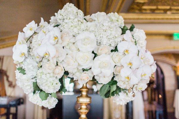 Tall centerpiece, white hydrangea, white roses, and white phalaenopsis