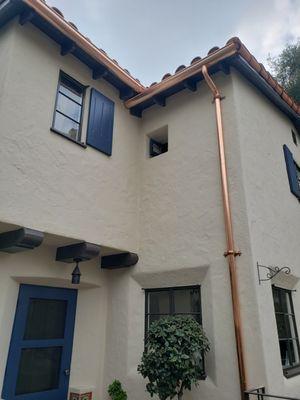 6 inch half round copper gutter and downspout with decorative brackets.