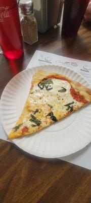 Margarita Pizza Slice ULTRA thin crust topped with oregano, basil, fresh mozzarella, and a slightly sweet tomato sauce.