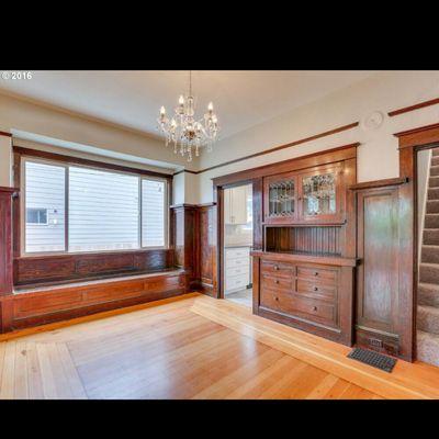 Fresh stain on original 1920s  walnut wainscoting and sanded orginal hardwood with clear coat stain