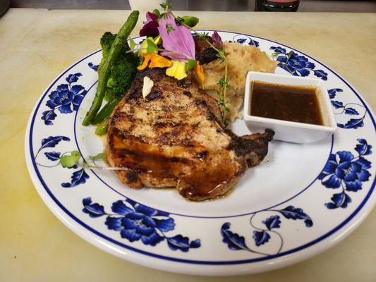 Grilled Pork Chop cooked to perfection. Topped with a Red Wine Sauce. Served with your choice of two Premium Sides