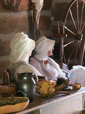 Volunteers portray pioneer ladies in the log cabin for special events at the Funk Heritage Center.