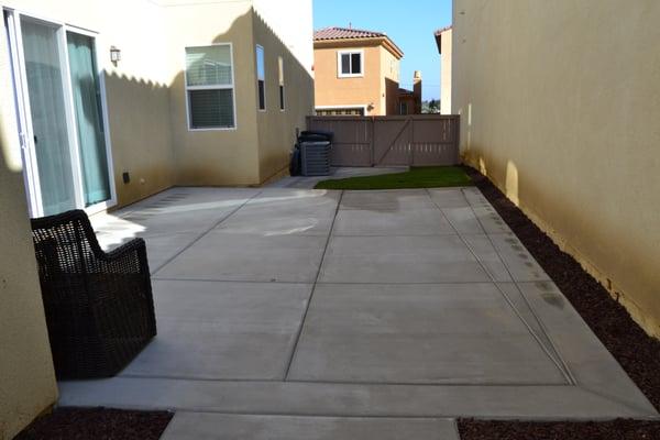 Taken from entryway into sideyard front.  Large concrete slab, natural drainage into new sod.