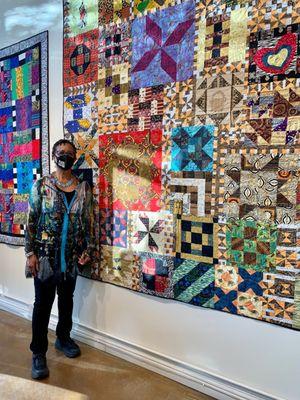 Vera Patterson, artist, in front of her piece, Solstice.