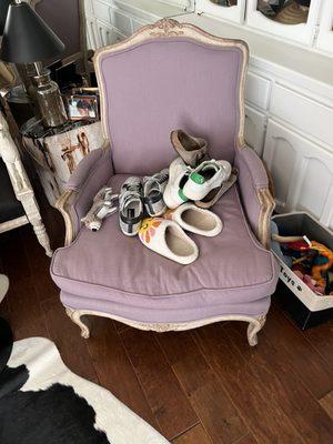 Dirty shoes left on top of my antique Swedish chair.