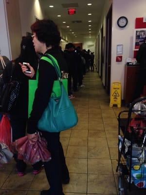 The line is literally out the door and spilling out onto the street. Flushing, you need another Bank of America!