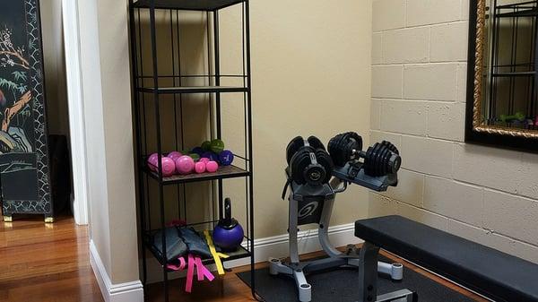 Weights and weight bench in Trimm-Way's fitness area.