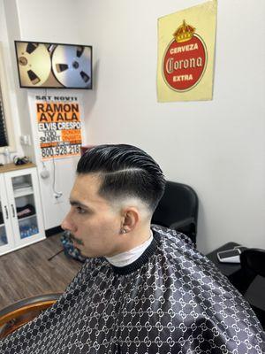 Mid fade comb over slick back.