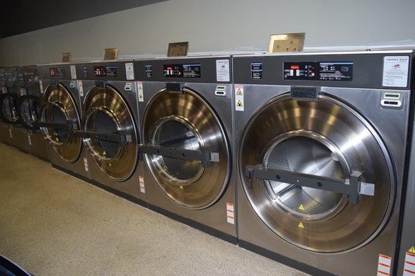 Four gigantic 8 load washers with four 75 lb dryers are in the store