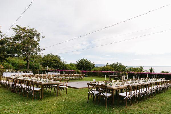 Hotel Wailea Wedding Reception Seating Farm Tables and Crossback Chairs. Wooden Dance Floor. Ocean View.