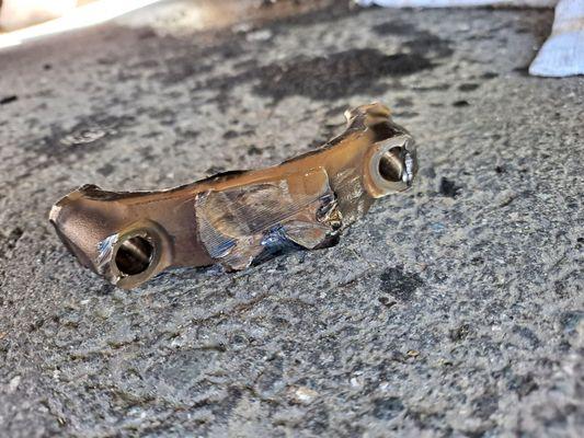 piece of the engine that fell out of the vehicle when the motor seized.