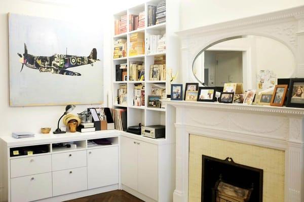 Built-in bookcases and cabinets around classic fireplace