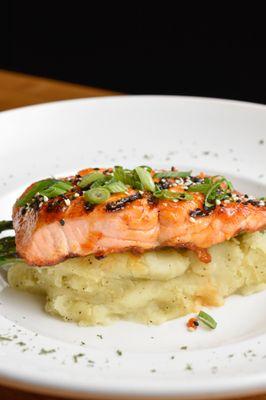 Perfectly grilled and glazed Asian ginger salmon over a bed of wasabi mashed potatoes and grilled asparagus.