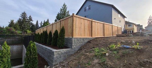 Retaining wall added to level out entire yard + fence