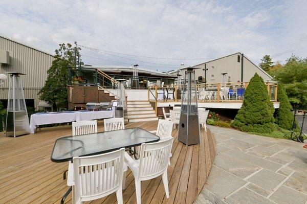 double level outdoor patio with heaters and string lights