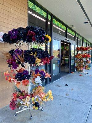 Faux flowers for sale outside of entrance