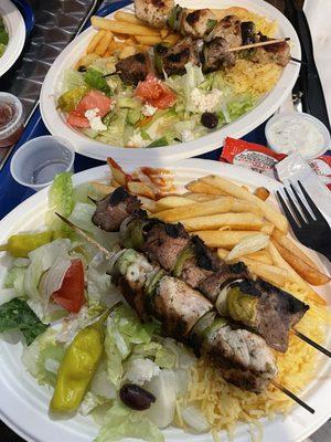 Dinner special, with a half serving of rice and half serving of fries, Greek salad, one chicken and one beef kabab.